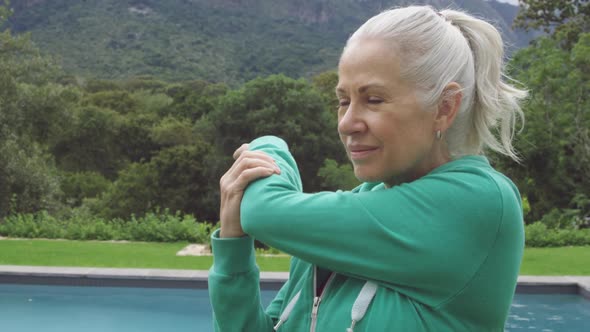 Senior woman exercising in a garden