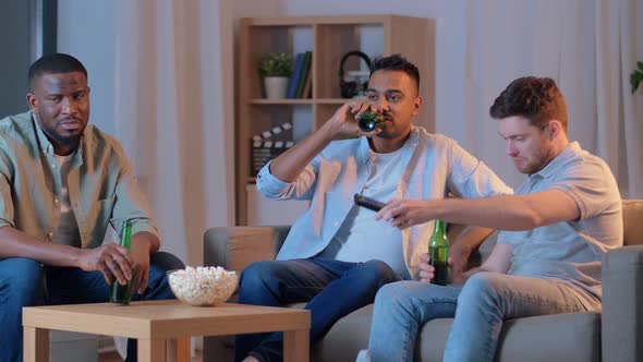 Happy Male Friends with Beer Watching Tv at Home