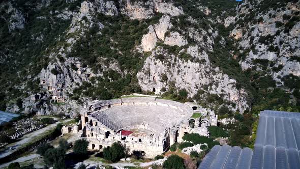 High angle drone aerial view of ancient greek rock cut lykian empire amphitheatre and tombs in Myra