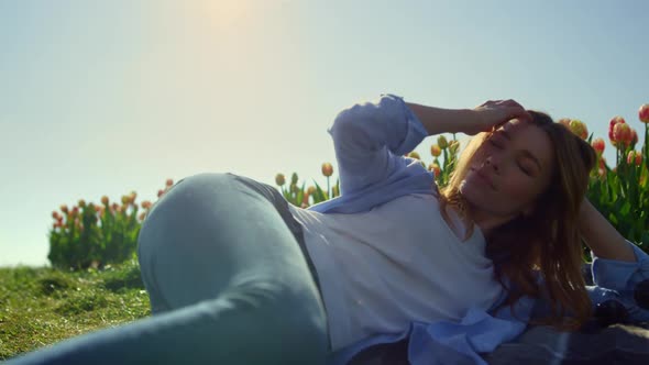 Relaxed Woman Lying in Tulip Garden