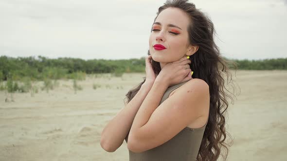 Pretty Woman Touching Hair on Beach