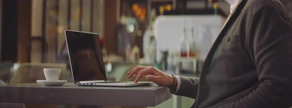 Man sitting in cafe and using laptop