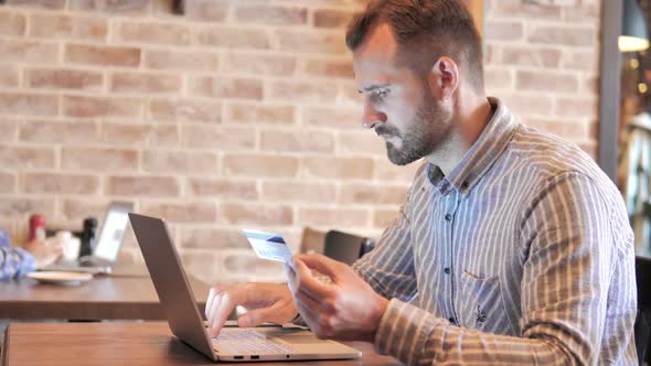 Online Shopping on Laptop By Young Man