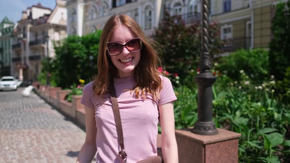 Beautiful Young Woman Tourist Walking in the City Center