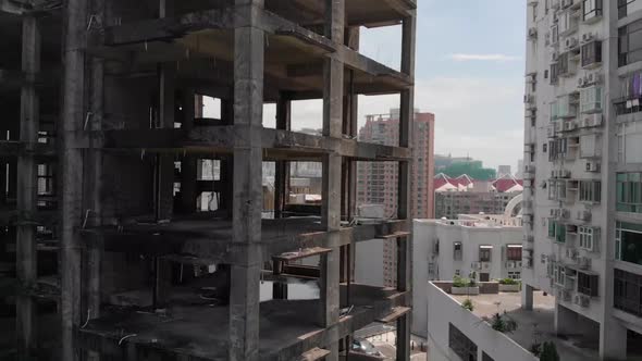 Lowering boom drone shot of derelict building in Macau