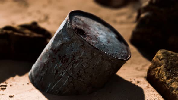 Rusty Metal Oil Barrel on Sand Beach