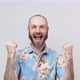 Happy man wearing hawaiian shirt celebrating a victory over white background. Emotions of success - VideoHive Item for Sale