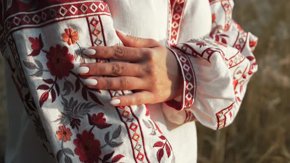 Ukrainian Woman Demonstrating Beautiful Details of Embroidery Ornament on Vyshyvanka Shirt