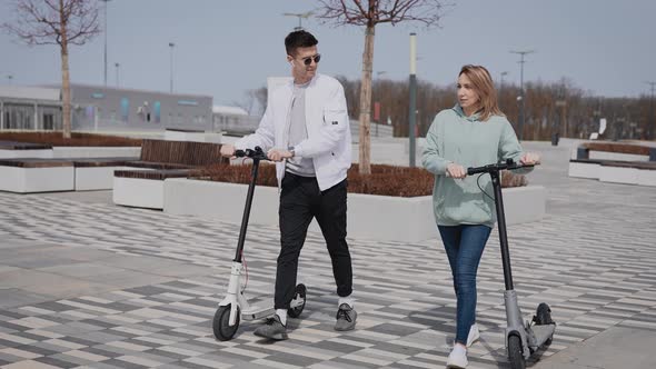 Young Man and Woman Communicate on the Street