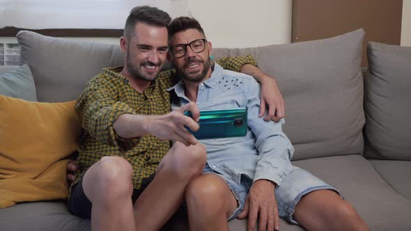 Young Smiling Gay Couple Taking Selfie at Home