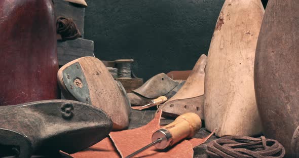 Cobbler workshop with tools, leather and strap. Vintage shoemaker workshop.