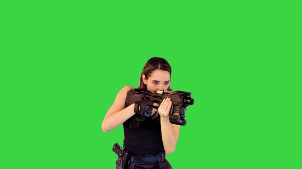 Cyberpunk Girl Walks with Machine Gun Taking an Aim Making a Single Shot on a Green Screen Chroma