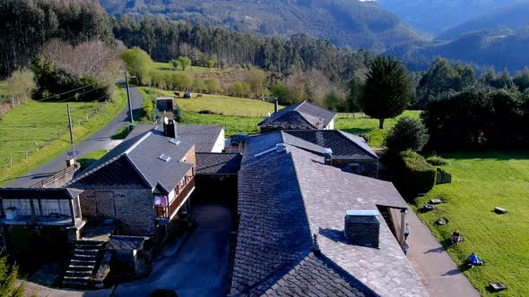 Aerial drone shot over an old typical house been converted into rural tourism house, Manón, Lugo, Ga