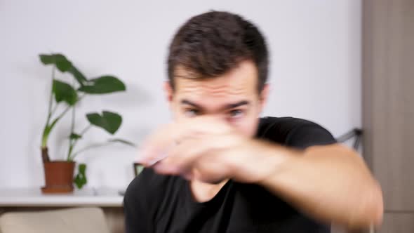 Fit Man Exercising at Practicing Box at Home