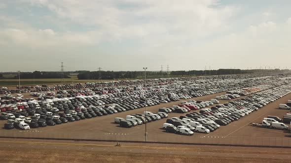 Many new and occasion Cars on a huge parking lot waiting for shipment, Aerial