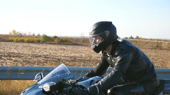 Young Man Riding on Modern Sport Motorbike at Highway