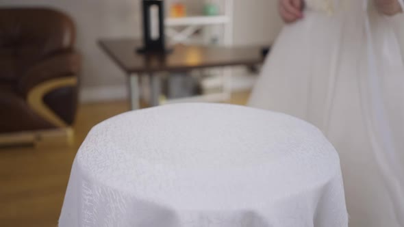 Closeup Table with Unrecognizable Bride in Wedding Dress Passing in Slow Motion Leaving Bridal