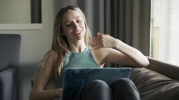 Woman on Sofa at Home Making Video Call Using Laptop on Self Isolation