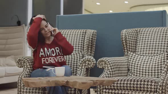 A Young Pretty Girl Works in a Cozy Office