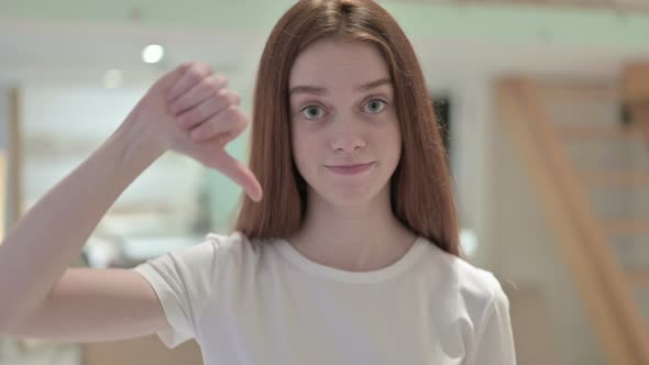 Portrait of Redhead Young Woman Doing Thumbs Down