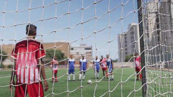 Soccer players having match on field