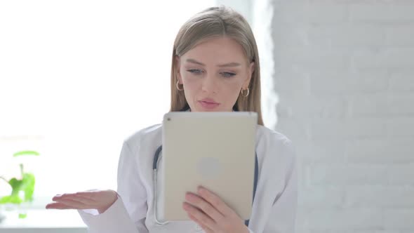 Portrait of Video Call on Tablet By Lady Doctor in Office