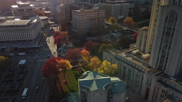 An autumn sunset tilt down aerial view above Forbes Avenue in the Oakland district of Pittsburgh, Pe