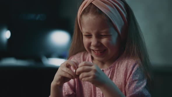 Girl with Grimace Tries Take Off Cap From Safe Pill Bottle