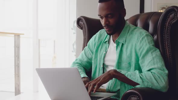 Young adult mixed race man enjoying time at home