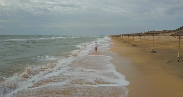 girl on the beach in a dress near the sea