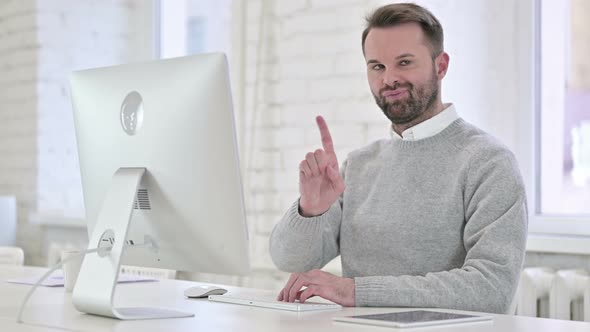 Creative Man Saying No with Finger Sign at Work