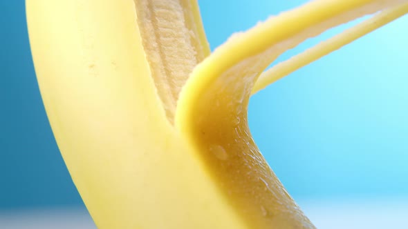 Macro Lens Shot Fresh Banana Gets Peeling on a Blue Background