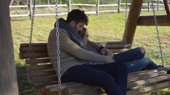 Young couple on a swing