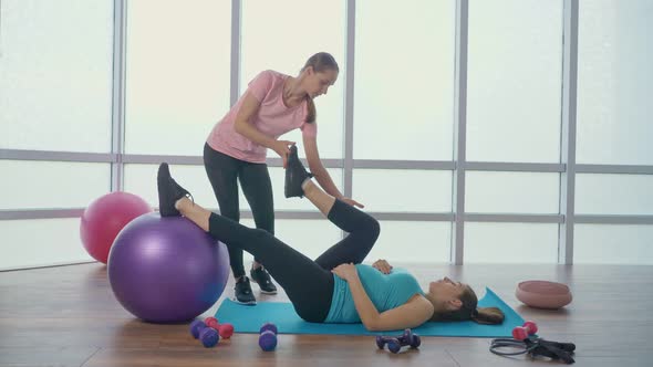 Pregnant Woman Doing Exercises for Pregnant Women with a Personal Trainer