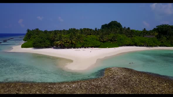 Aerial flying over abstract of tranquil seashore beach wildlife by transparent sea and white sand ba