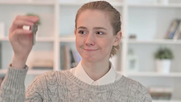 Portrait of Successful Young Woman Holding Key