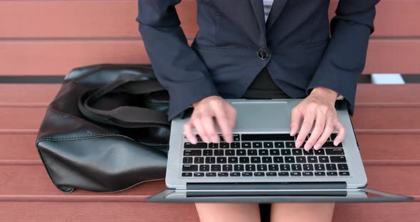 Business woman work on notebook computer at outdoor