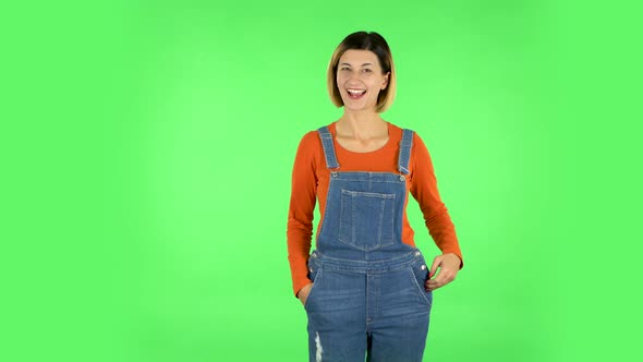 Cute Girl Smiles and Showing Heart with Fingers Then Blowing Kiss. Green Screen