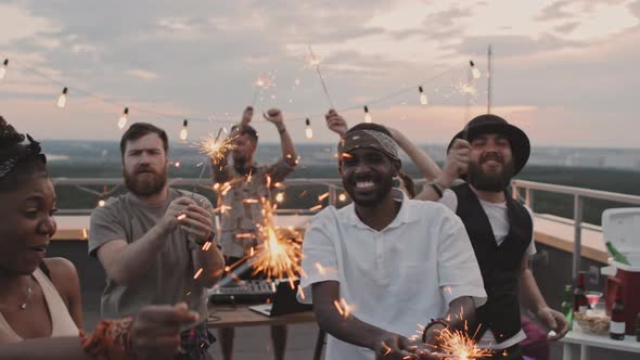 People with Sparklers Partying at Rooftop Party