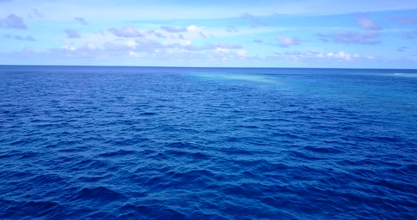 Wide above tourism shot of a sandy white paradise beach and blue water background in best quality 