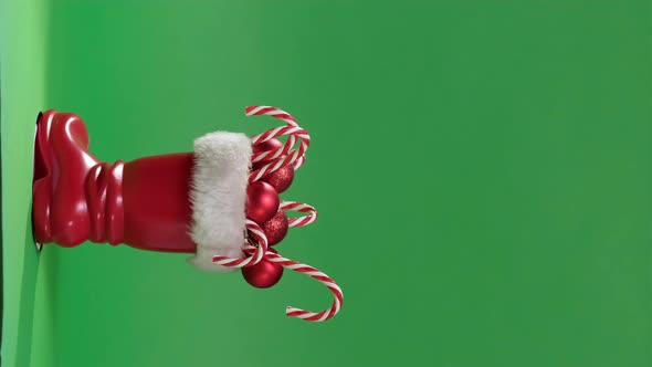 Vertical Video Christmas Scene with Red Boot of Santa Claus