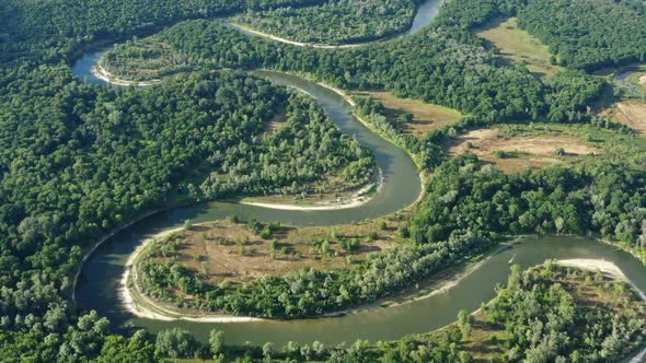 Aerial View of Winding River in Forest