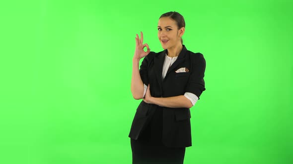 Smiling Girl Makes Sign Ok. Green Screen