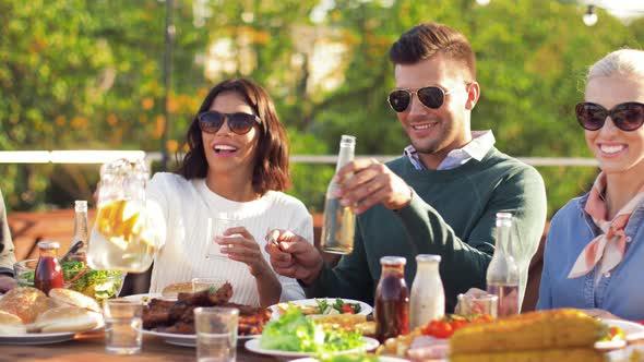 Happy Friends Eating and Drinking at Rooftop Party 4