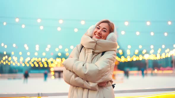 Woman Frozen on Winter Street Hugging Himself Dressed Warm Winter Clothes and Earmuffs Standing