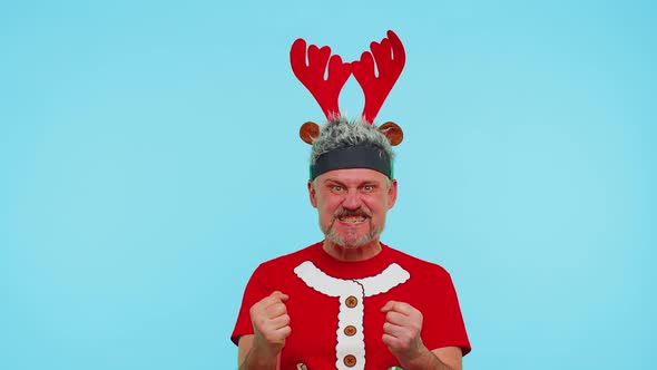 Displeased Man in Christmas Tshirt Gesturing Hands with Displeasure Blaming Scolding for Failure