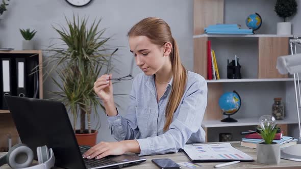 25-Aged Girl Which Working at The Computer,taking Off Her Glasses,rubbing Eyes