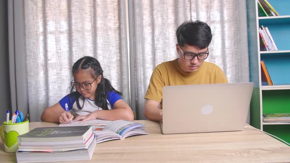 Father Working And His Daughter Learning at Home