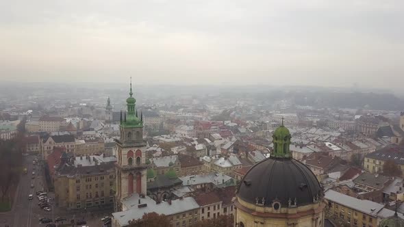 Aerial: Cityscape of Lviv in misty weather