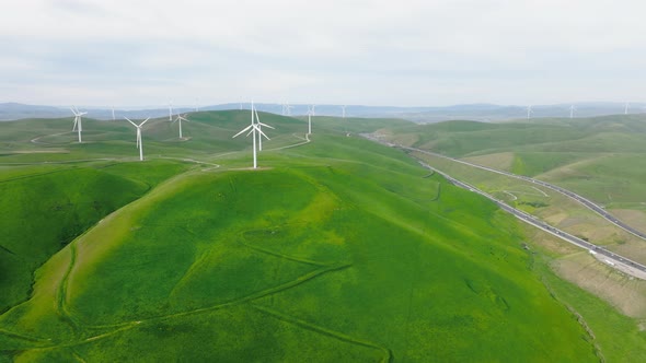 Aerial View of Powerful Wind Turbine Farm for Energy Production Under Cloudy Sky